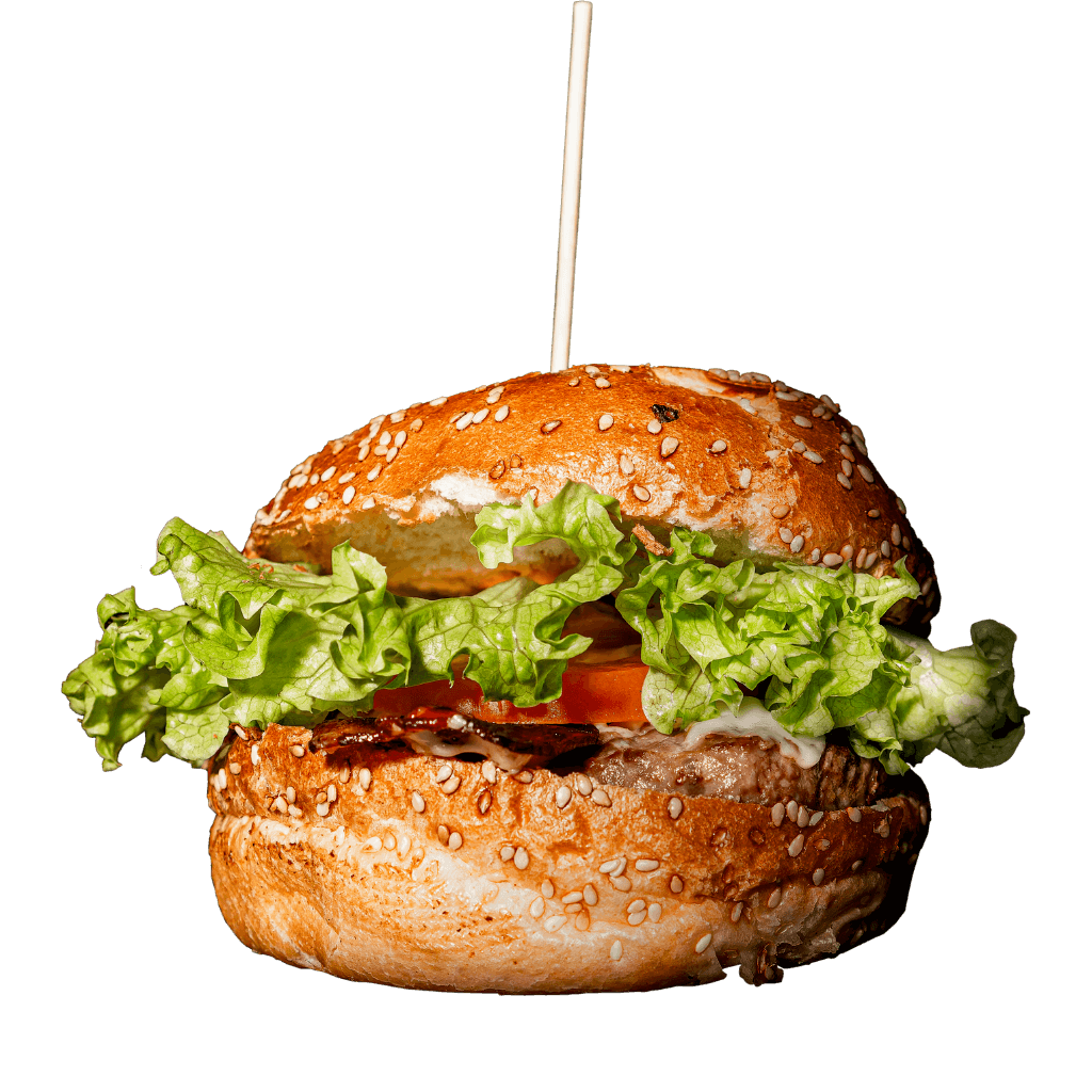 Gros plan sur un burger avec salade et tomate du American Pub à Sion, restaurant de burgers et ambiance américaine